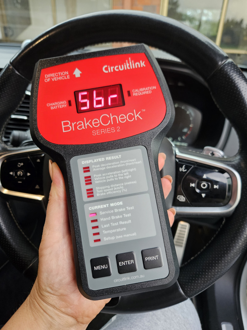 Man Holding Circuitlink Electronic Brake Check - Brake Meter Certification Tauranga